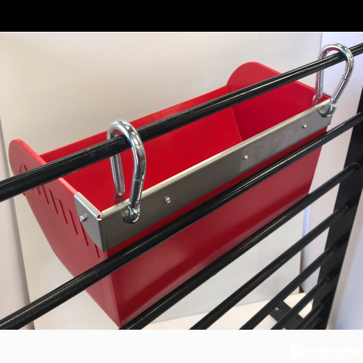hanging piglet creep feeder with stainless steel guard installed on pen rail