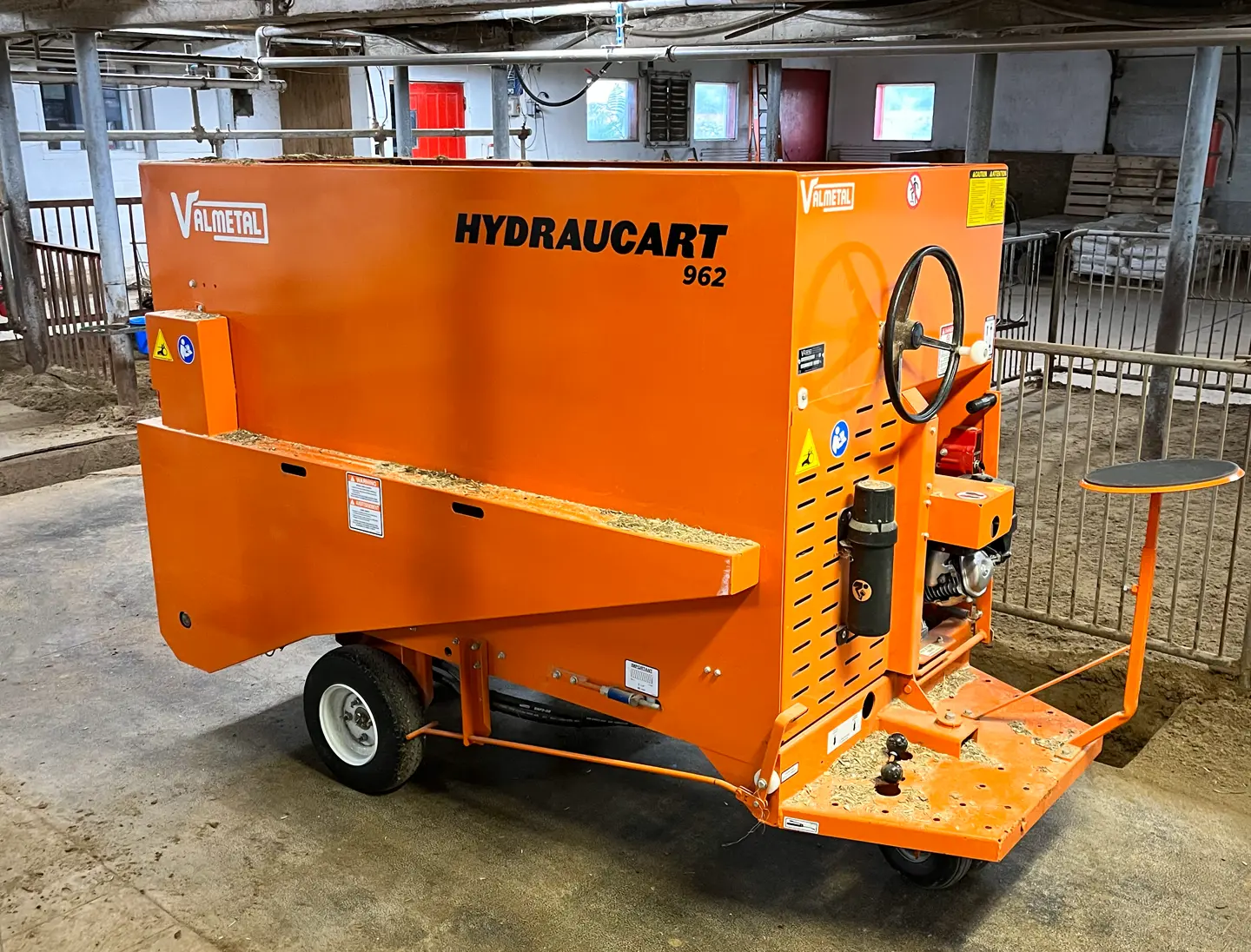 Motorized Livestock Feed Distribution Cart in Barn
