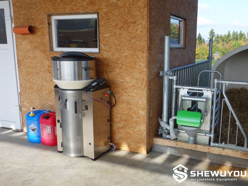 automatic milk replacer calf feeder installed in dairy barn