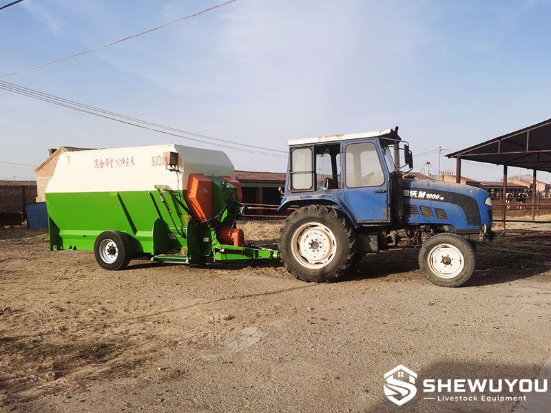 tractor trailed horizontal TMR feed mixer in cattle farm