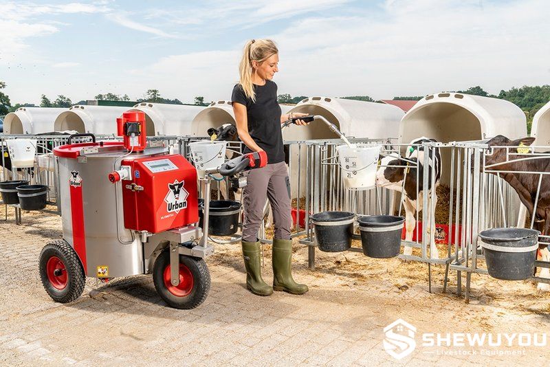 calf milk shuttle dispensing milk at outdoor hutches
