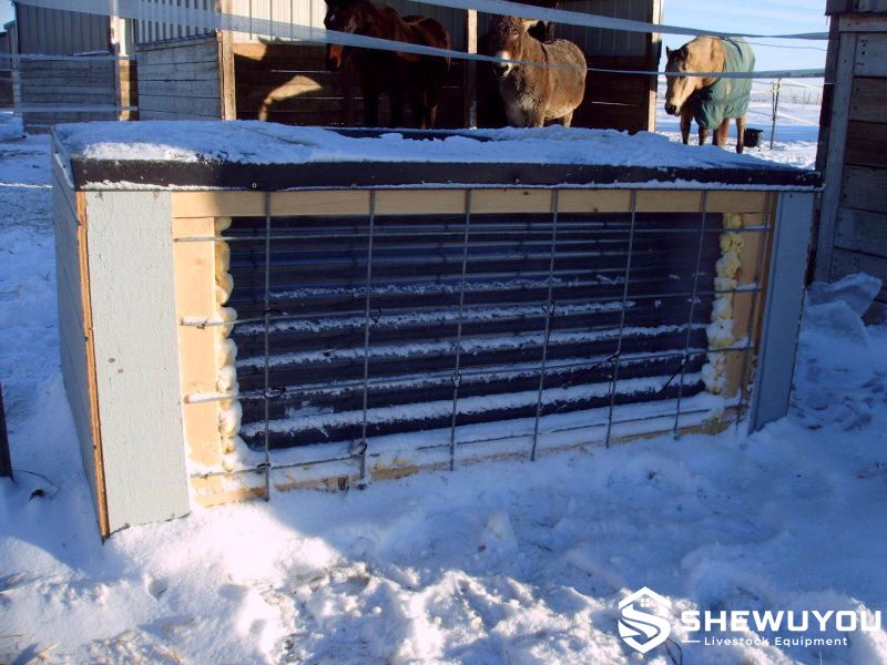 Solar heated livestock stock tank in snowy winter conditions