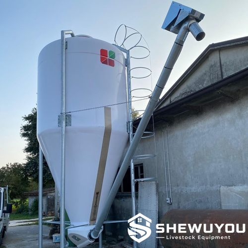 rigid tubular screw conveyor connected to livestock feed silo
